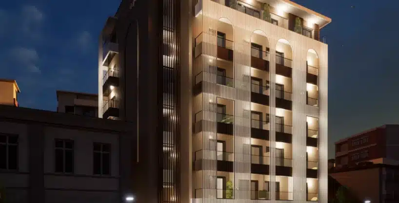 Illuminated exterior of The Alcyon apartments in Kavala