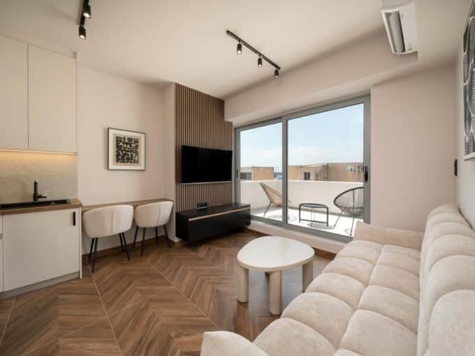 Open kitchen and lounge beside the furnished balcony