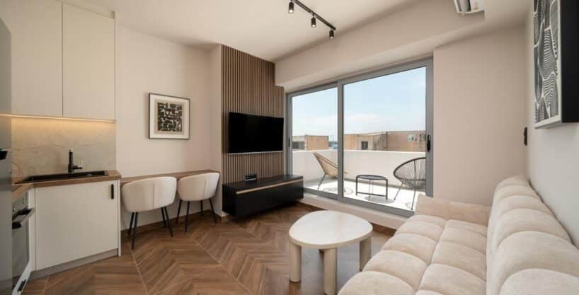 Open kitchen and lounge beside the furnished balcony